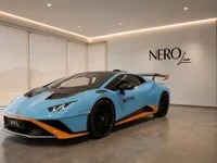 A light blue Lamborghini Huracán STO is showcased from the front three-quarter angle in a modern showroom in Lausanne.