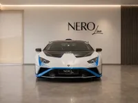 White Lamborghini Huracán STO front view parked in a modern showroom in Zurich.