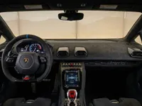 The luxurious interior of the Lamborghini Huracán STO, featuring the steering wheel, digital dashboard, and central console in Zurich.