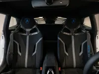 Lamborghini Huracán STO interior showcasing black sports seats with blue accents and embroidered logos in Zurich.