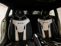 The interior of the Lamborghini Huracán STO in Zurich, featuring its distinctive black and white racing seats with STO branding.