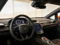 The luxurious interior cockpit of the 2024 Lamborghini Revuelto in Lausanne, featuring the steering wheel, digital dashboard, and infotainment screen.