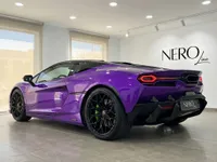 The Gloss Metallic Purple Lamborghini Temerario supercar is showcased from a rear three-quarter angle in a Madrid showroom.