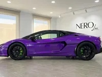 The striking Gloss Metallic Purple Lamborghini Temerario is showcased in a showroom, viewed from its elegant side profile in Madrid.