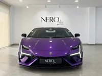 The Lamborghini Temerario in Gloss Metallic Purple is showcased from a direct front view in a showroom in Madrid.