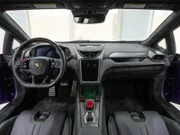 The luxurious interior cockpit of the Lamborghini Temerario in Madrid, featuring the steering wheel, dashboard, and black seats with green stitching.