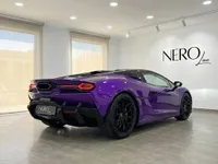 The Gloss Metallic Purple Lamborghini Temerario supercar is showcased from a rear three-quarter angle in a showroom in Madrid.