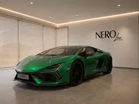 The gloss metallic green Lamborghini Temerario is parked in a modern showroom in Zurich, visible from a front three-quarter view.