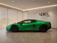 The gloss metallic green Lamborghini Temerario is showcased from its side profile in a modern showroom in Zurich.