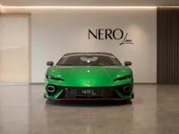 The gloss metallic green 2025 Lamborghini Temerario is prominently displayed in a showroom, viewed from the front in Zurich.