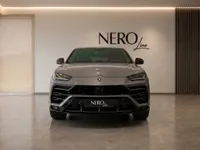 The grey 2021 Lamborghini Urus is presented head-on in a modern Zurich showroom with the NEROline logo visible.