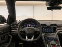 The luxurious interior of the Lamborghini Urus Performante in Zurich, showcasing the steering wheel, digital dashboard, and dual infotainment screens.