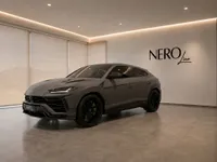 The grey Lamborghini Urus Performante is showcased in a modern showroom with the NEROline logo on the wall in Zurich.