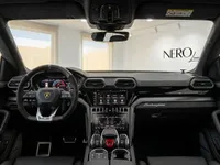 The luxurious interior of the Lamborghini Urus SE in Barcelona, featuring its advanced digital cockpit, steering wheel, and central console.