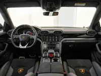 The luxurious black interior of the Lamborghini Urus SE, showcasing its advanced cockpit and dashboard in Barcelona.