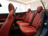 The luxurious interior of the Maserati GranCabrio in Lausanne, featuring vibrant red leather rear and front passenger seats.
