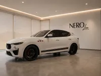 The white Maserati Levante Trofeo SUV is parked in a modern showroom with the NEROline logo in Zurich.