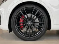 Close-up of the Maserati Levante Trofeo's black alloy wheel with vibrant red brake caliper in Zurich.