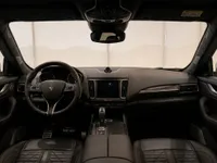 The luxurious interior cockpit of the Maserati Levante, featuring the dashboard, steering wheel, and quilted leather seats in Zurich.