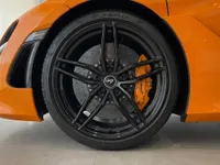 The gloss orange McLaren 750S Spider features a black multi-spoke front wheel with bright orange brake calipers in Zurich.