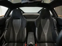 The image shows the luxurious interior of the McLaren 750S Spider, highlighting the two sports seats and central console in Zurich.