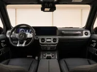 The luxurious interior cockpit of the Mercedes-AMG G 63, showcasing the dashboard, steering wheel, and front seats in Zurich.