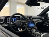 The luxurious cockpit of the Mercedes-Benz C63 AMG in Alicante, featuring its steering wheel, digital dashboard, and central infotainment screen.