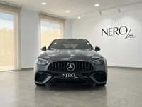 The dark metallic grey Mercedes-Benz C63 AMG is showcased head-on in a bright showroom in Alicante.
