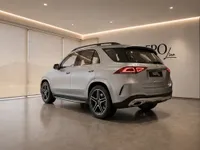 A metallic silver Mercedes-Benz GLE 350d is parked indoors, shown from a rear three-quarter view in Lausanne.