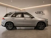 The metallic silver Mercedes-Benz GLE 350d luxury SUV is presented in a showroom with the NEROline logo in Lausanne.