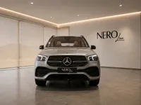 Front view of the metallic silver Mercedes-Benz GLE 350d in a modern showroom in Lausanne.