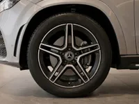 The front wheel and part of the metallic silver Mercedes-Benz GLE 350d, showcasing its distinctive rim design in Lausanne.