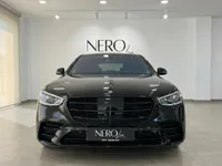 Front view of the gloss black Mercedes-Benz S 450 4MATIC luxury sedan in a showroom in Alicante, Spain.