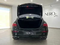 The black Mercedes-Benz S 450 4MATIC is shown from the rear with its trunk open, in a showroom in Alicante, Spain.