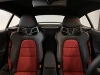 The interior of the Porsche 718 Spyder RS in Zurich, featuring black and red sports seats with Weissach RS embroidery.