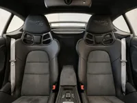 The interior of the Porsche 718 Spyder RS in Zurich, showcasing its black Weissach RS bucket seats and central console.