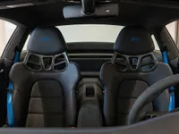 Porsche 911 Dakar interior showing black leather sport seats with blue accents and seatbelts in Zurich.