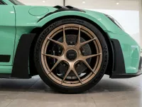 The Gloss Mint Green Porsche 911 GT3 RS showcases its distinctive gold front wheel and fender details in Zurich.