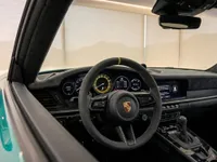 The luxurious interior of the Porsche 911 GT3 RS in Zurich, featuring its advanced steering wheel and digital dashboard displays.