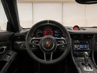 The luxurious interior of the Porsche 911 GT3 RS (991.1) in Zurich, featuring the steering wheel, dashboard, and infotainment system.