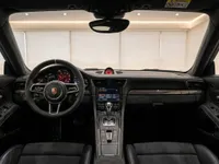 The luxurious interior of the Porsche 911 GT3 RS, featuring the steering wheel, dashboard, and central console in Zurich.