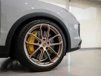 Close-up of the Porsche Cayenne Turbo GT's bronze wheel and yellow brake caliper in Zurich.