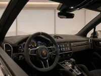 The luxurious interior cockpit of the Porsche Cayenne Turbo GT in Zurich, featuring its distinctive steering wheel and advanced dashboard.
