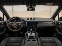 The luxurious interior cockpit of the Porsche Cayenne Turbo GT in Zurich, featuring a multi-function steering wheel and central infotainment screen.