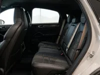 The luxurious rear interior of the Porsche Cayenne Turbo GT in Zurich, showcasing its black leather seats and ample space.