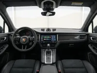 The luxurious interior of the Porsche Macan GTS in Lausanne, showcasing its sporty steering wheel, modern dashboard, and central infotainment screen.