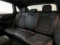The luxurious black leather and Alcantara rear seats with red stitching and 'GTS' embroidery in the Porsche Macan GTS, available in Lausanne.