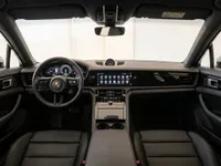 Porsche Panamera 4S E-Hybrid interior in Lausanne, showcasing its modern dashboard, steering wheel, and black leather front seats.