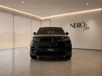 The sleek black 2023 Land Rover Range Rover Sport is prominently displayed in a modern showroom in Lausanne, featuring the NERO line logo.