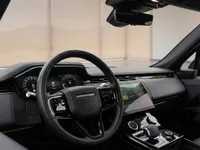 The luxurious cockpit and dashboard of the 2023 Land Rover Range Rover Sport in Lausanne, featuring the steering wheel and central display.